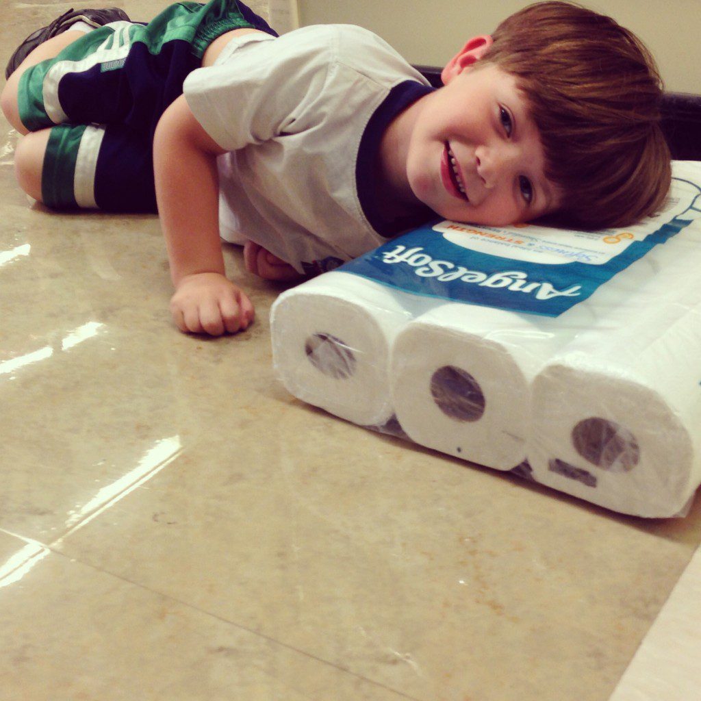 Jack laying on a package of toilet paper