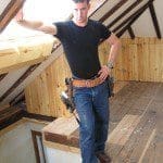 Mark is standing at the top of the attic stairs, under the skylight