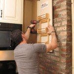 Mark installing the spice rack.