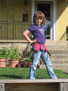 Lexi posing in her pink toolbelt
