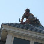 Mark installing synthetic slate tiles