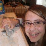 Justine pouring detergent onto a cotton piece.