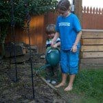 10yo Lexi waters plants with her brother Jack