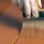 Applying deck stain.