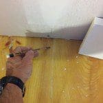Mark the stud locations on the floor before installing baseboard.