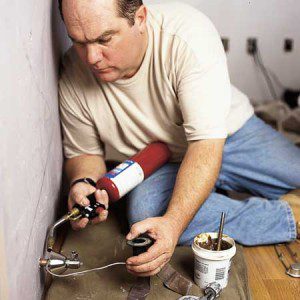 Licensed master and journeyman plumber, Rich Trethewey, installing a toilet