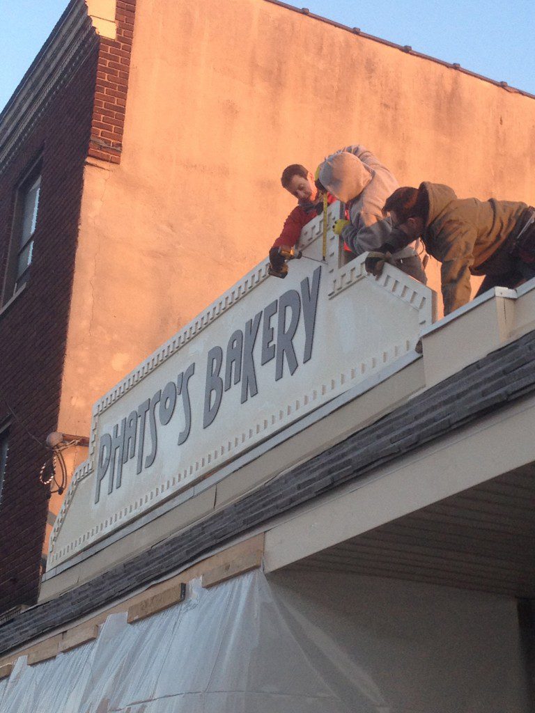 Installing the sign on Save My Bakery
