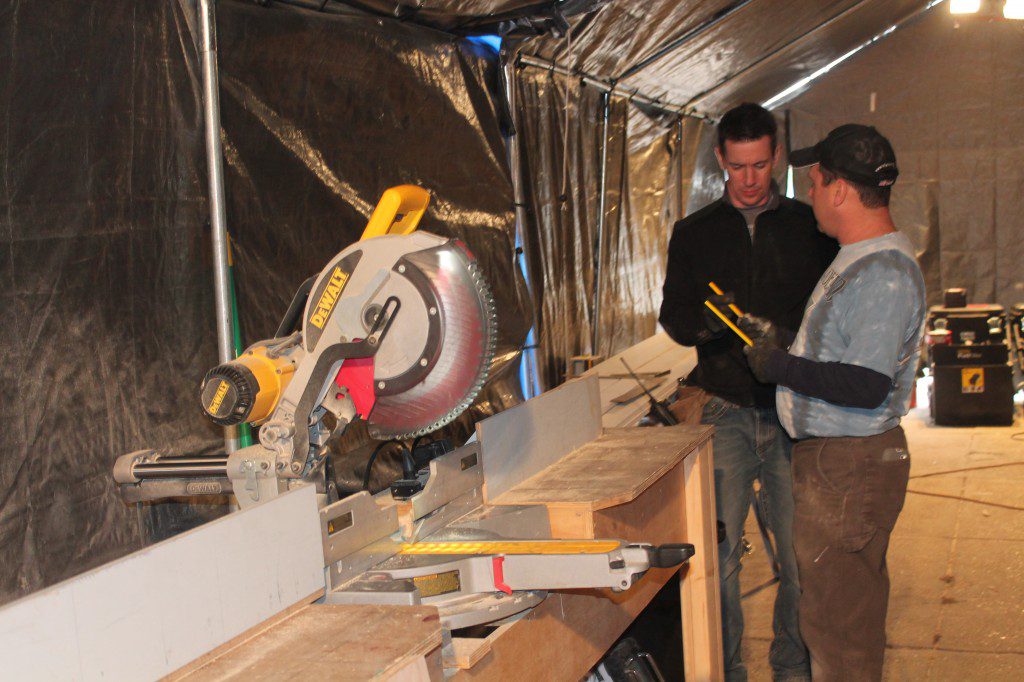 During Schenk's Family Bakery makeover, Andy and Mark making plans in the tool tent.