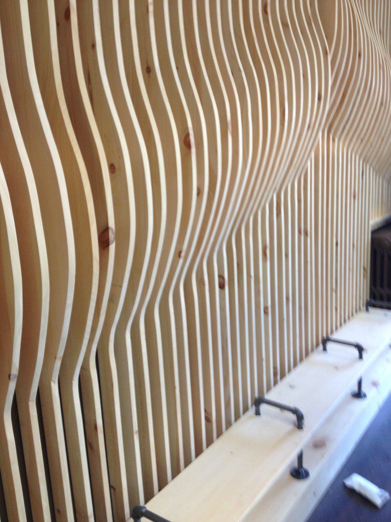 Undulating wall of pine boards as a feature in Holmesburg Bakery, Save My Bakery