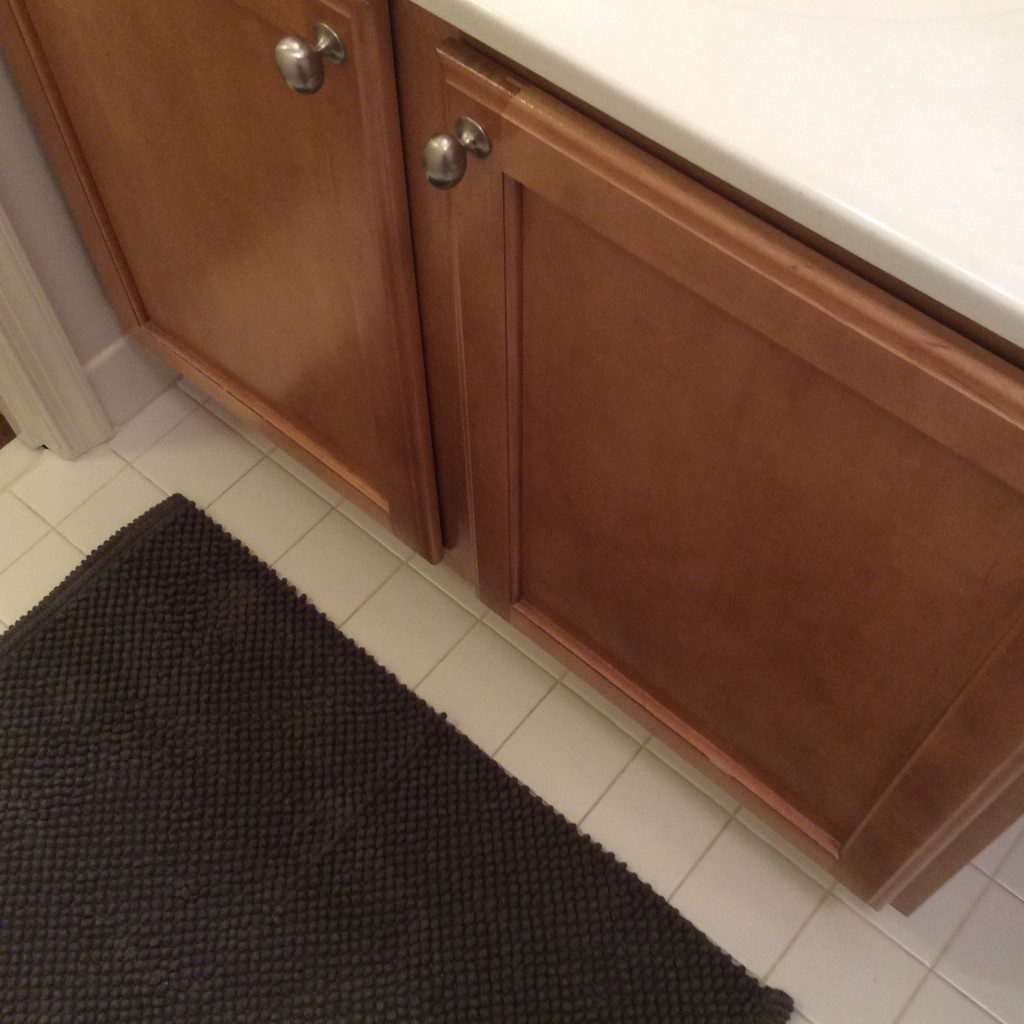 Even though my mom wanted a very gentle color palette in her small bathroom, I talked her into a textured rug in a darker shade. It grounds the space. 