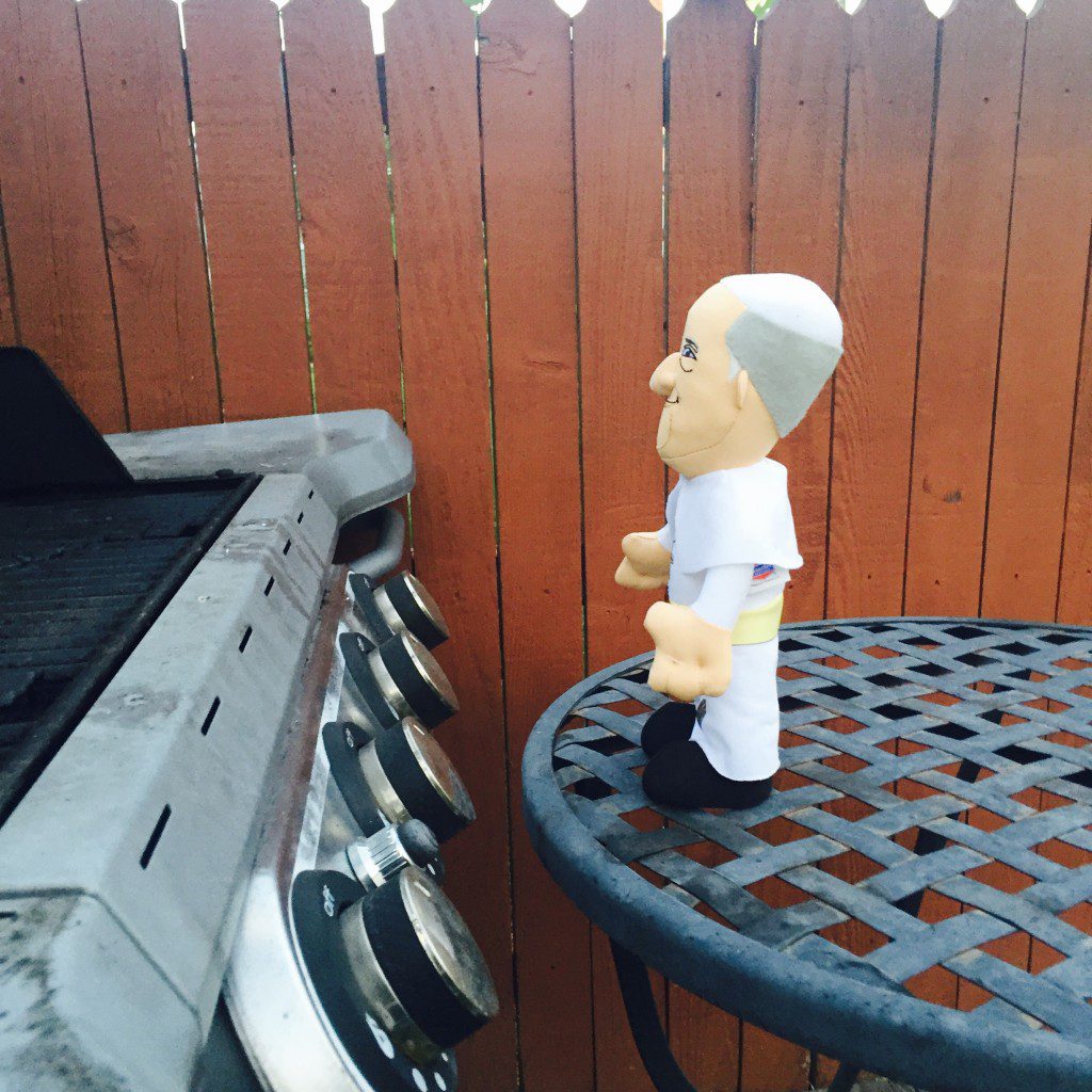 Plush Pope Francis was hungry so he grilled some food.