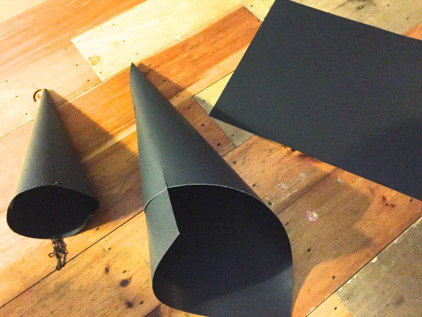Three pieces of black poster board is the only supply I had to buy. I wrapped each in a cone shape, taped it, then trimmed the bottom to make them sit level. 
