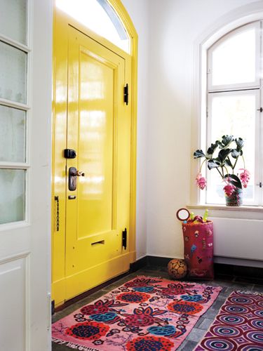 Yellow, violet and red-orange combine for an energetic triad color scheme in this entryway.