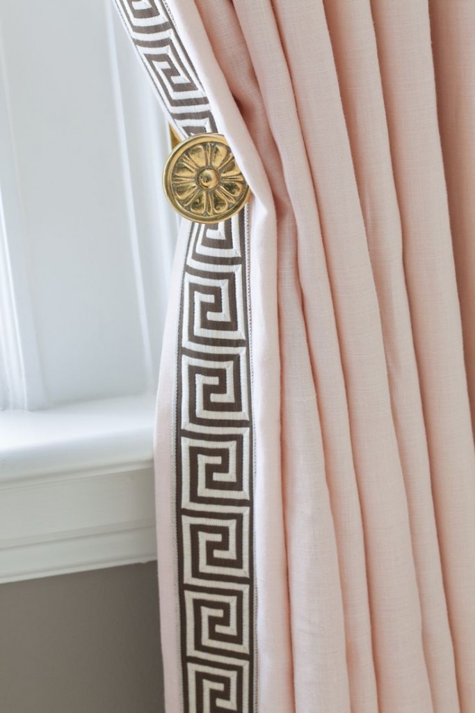 Yes, you can use pink in a formal room. The Pantone color of the year, Rose Quartz, is a perfect hue with the curtain tie-back and Greek Key pattern trim in black and white.