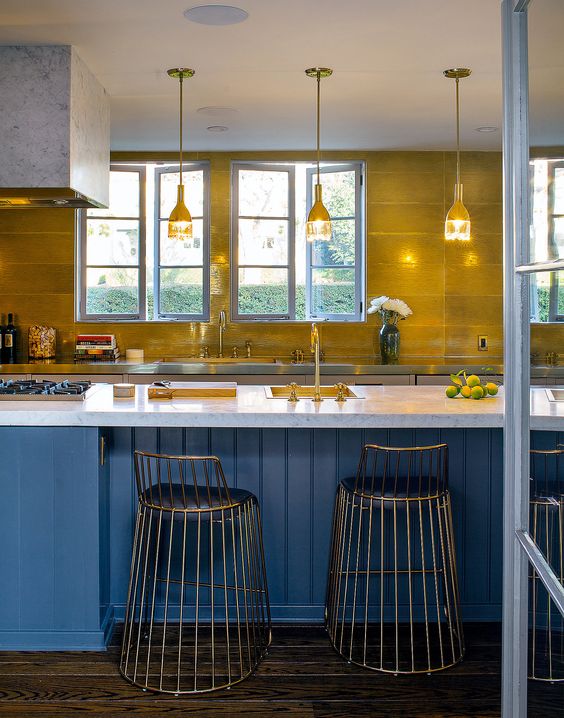 The best part of the mixing metals in this kitchen is that it's not noticeable... until you 'really' look. •A Howard Hughes home shows the mix of chrome, gold, and aged bronze. There’s gold grout between those Ann Sacks gold tile. from NYTimes.com, spotted by Laurie March