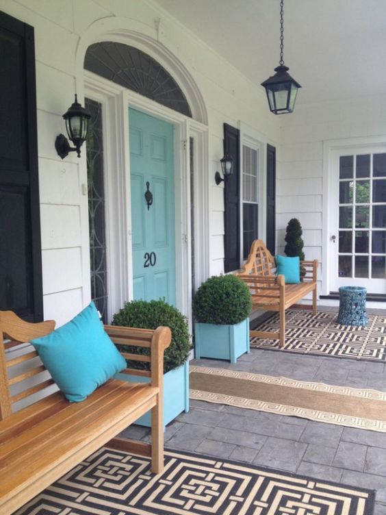 front door colors The black-white-and-wood porch might make most select a black or wood door. The aqua blue front door gives personality about the creamy white siding and black accents.