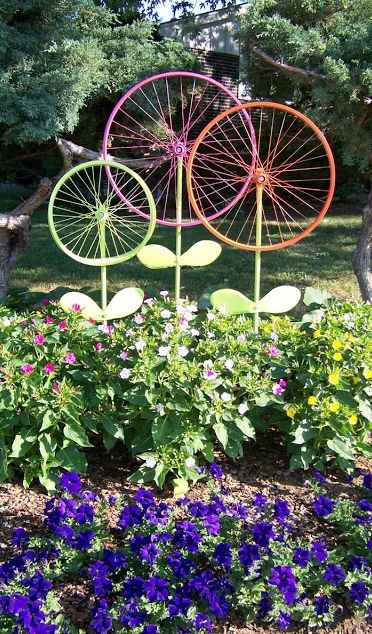 Old bicycle tires painted vibrant colors adds such a charming element to a garden. 