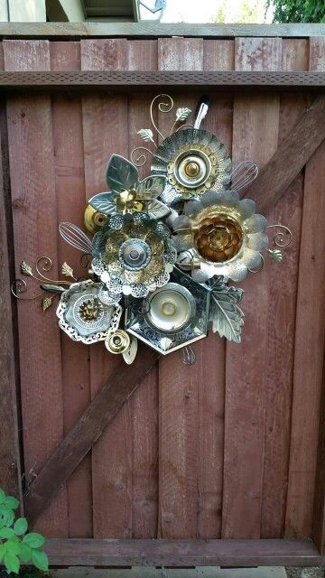 Outdoor wall art made from old kitchen tools. Love it!