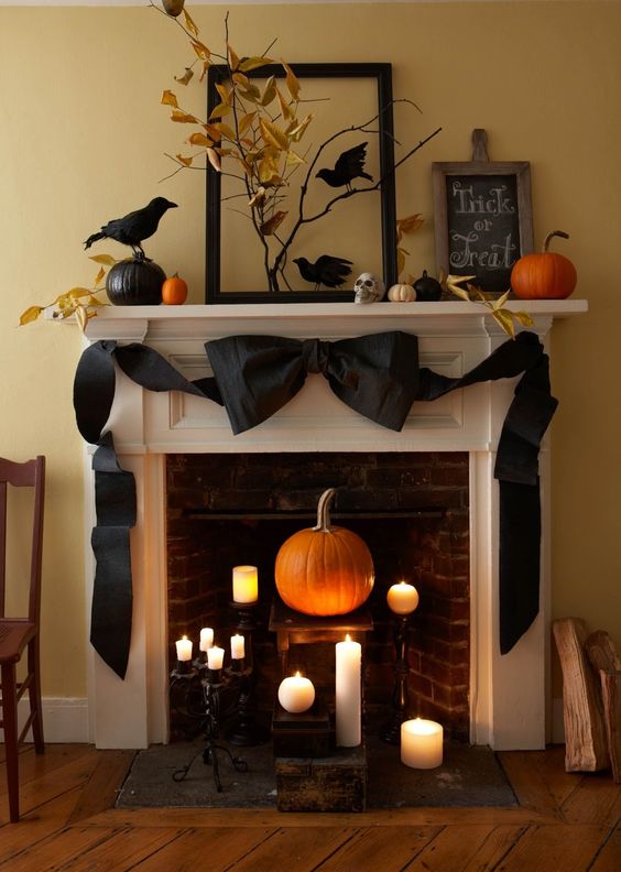 myfixituplife Halloween mantel with black ribbon, ravens, pumpkins, candles.