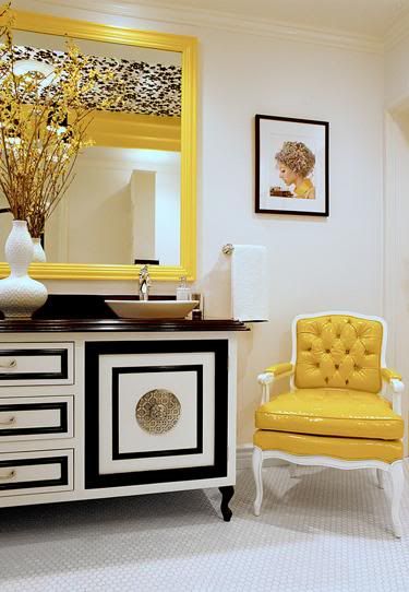 yellow tufted chair and yellow framed mirror