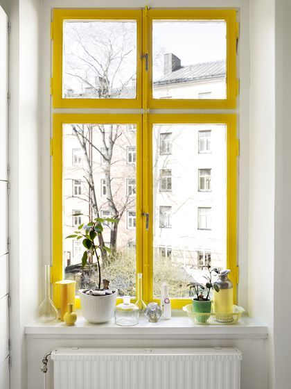 A yellow window frame can make even the dreariest rainy days a little brighter. 