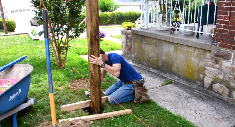 3 MyFixitUpLife How to place a fence post_secure the fence post to scrap wood at the base