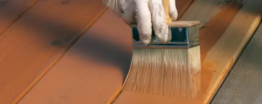 Applying deck stain.