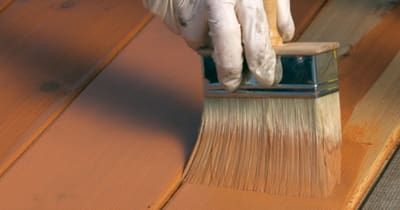 Applying deck stain.