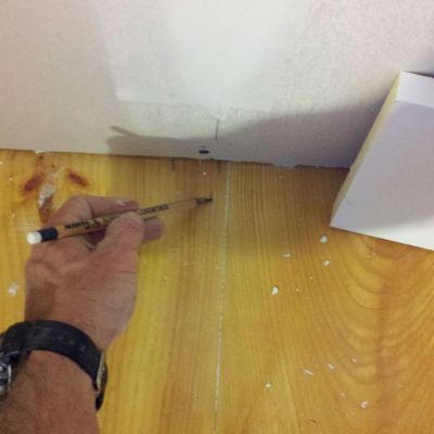 Mark the stud locations on the floor before installing baseboard.