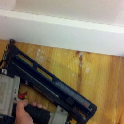Nailing baseboard.