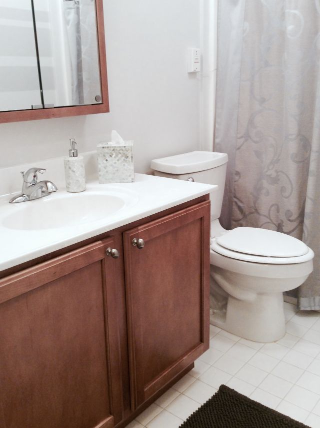 After painting, decreasing the visual noise of wall art and counter items, the small bathroom looks more like a hotel bathroom than a kid's bathroom.