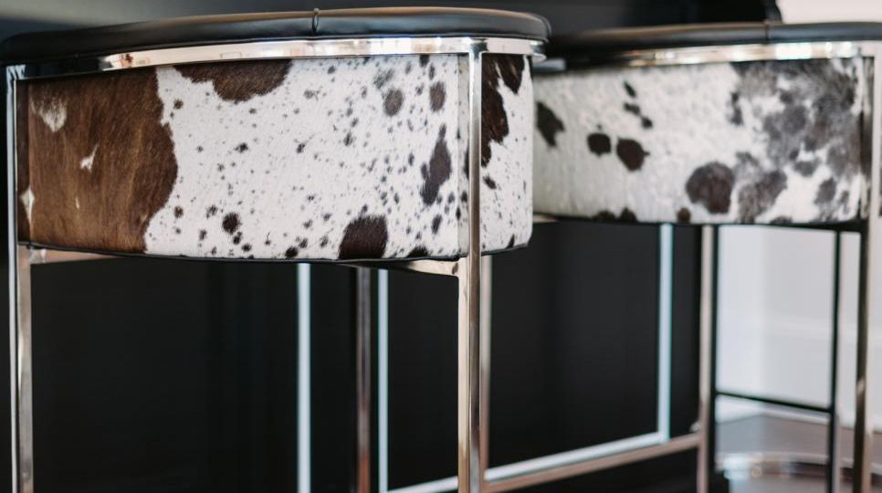 This Arteriors Calvin barrel-style tufted barstool is covered in top grain black and white hide leather. I spotted the cowhide barstool on HGTV.com.