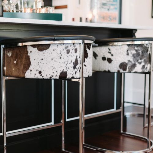 This Arteriors Calvin barrel-style tufted barstool is covered in top grain black and white hide leather. I spotted the cowhide barstool on HGTV.com.