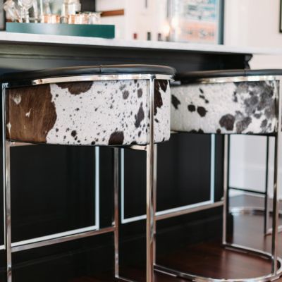 This Arteriors Calvin barrel-style tufted barstool is covered in top grain black and white hide leather. I spotted the cowhide barstool on HGTV.com.