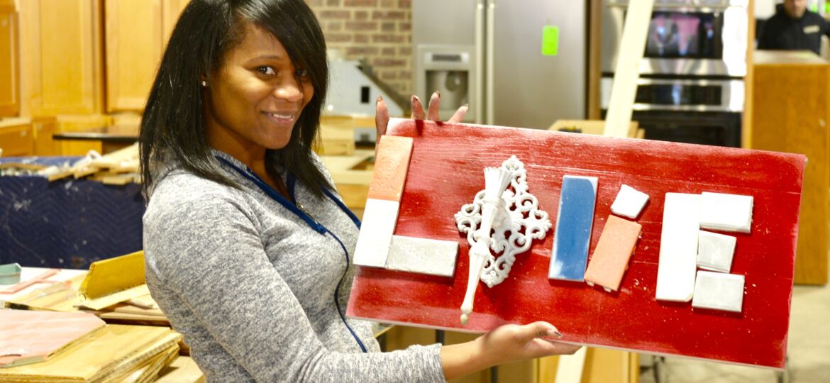 Jessica Massaquoi made this Love wall art with a wall sconce and tile at the Habitat for Humanity ReStore workshop.