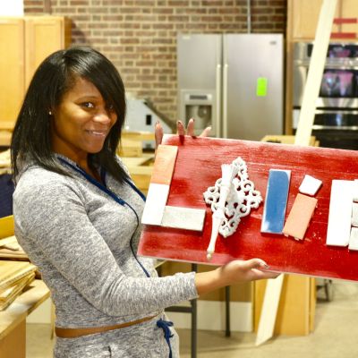 Jessica Massaquoi made this Love wall art with a wall sconce and tile at the Habitat for Humanity ReStore workshop.