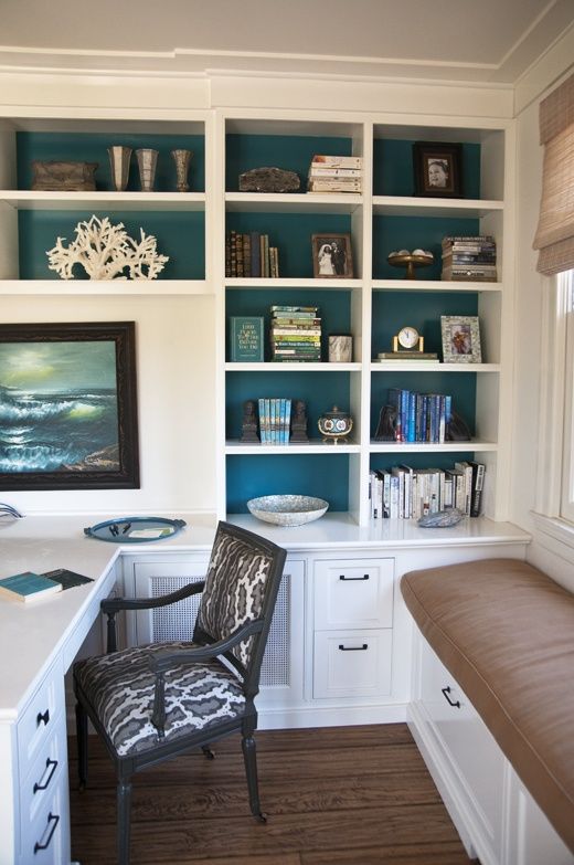The blue pops on the backs of these shelves help to give vibrancy to this home office. The cushioned window seat might be your pet's favorite new spot, too.