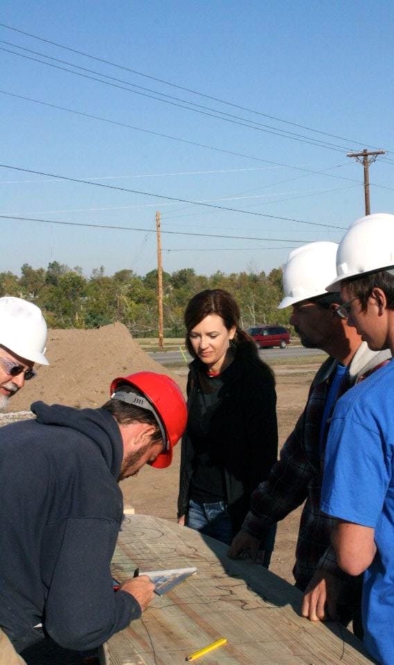 Theresa working with a group of craftspeople on site at an Extreme Makeover project in Joplin.