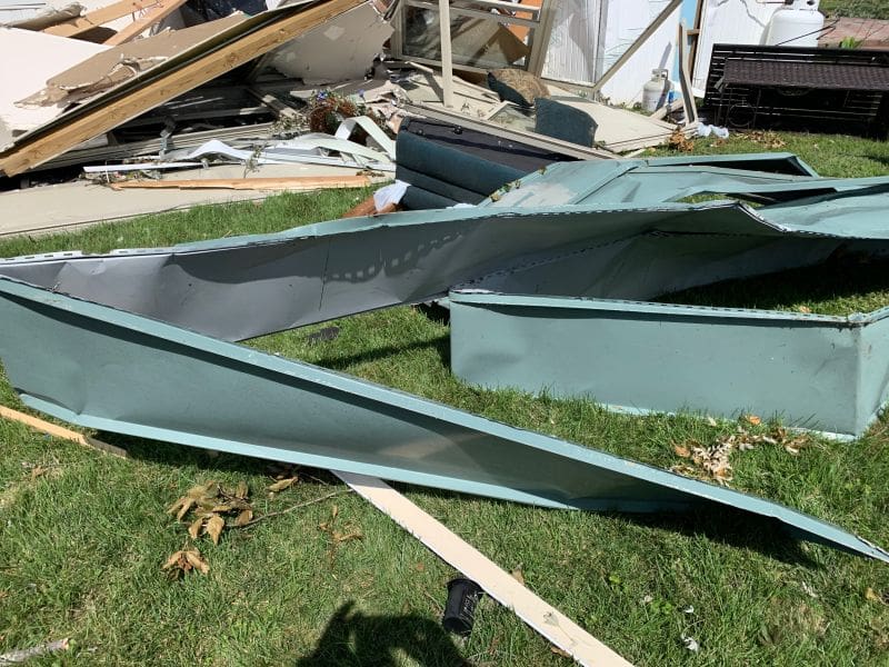 Fort Washington Tornado 8 Why I Joined a Tornado Clean Up Chainsaw Gang MyFixitUpLife Tangled wreckage of a collapsed metal structure on a grassy yard with wood beams and debris scattered about MyFixitUpLife